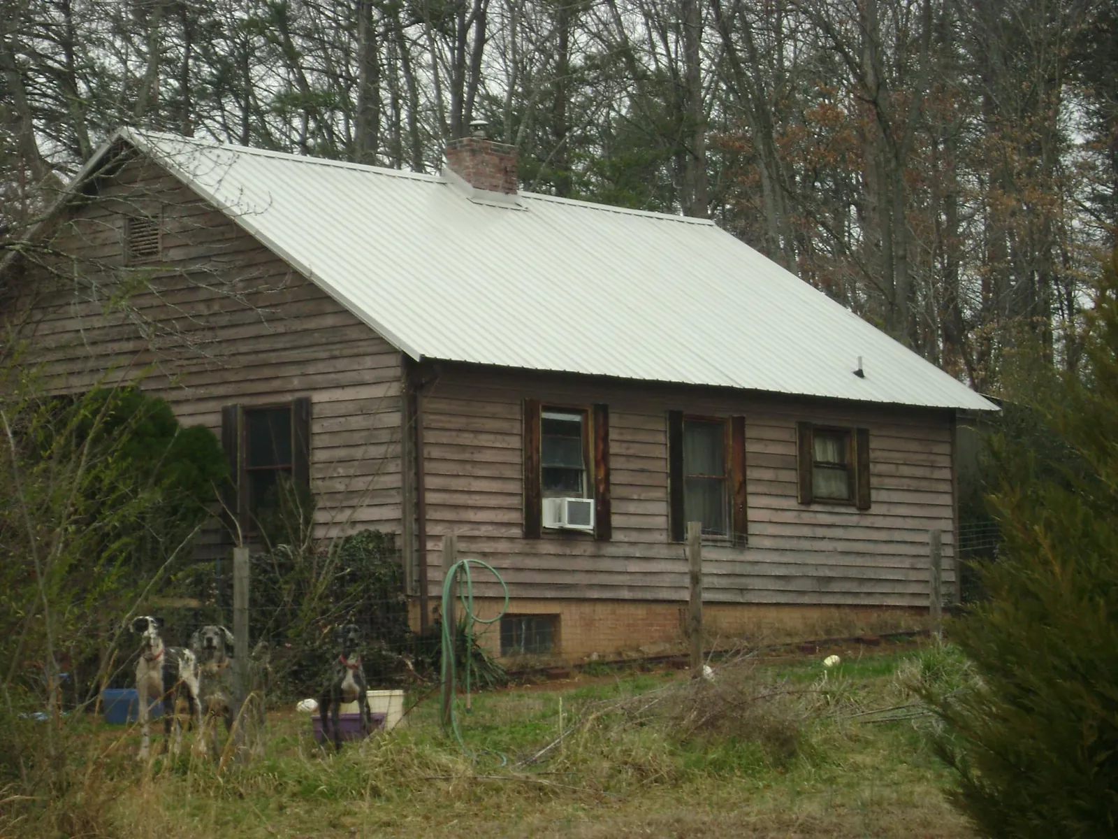 White metal roof on an old wood sided farmhouse, from a Metal Roof Installation job in Glen Campbell